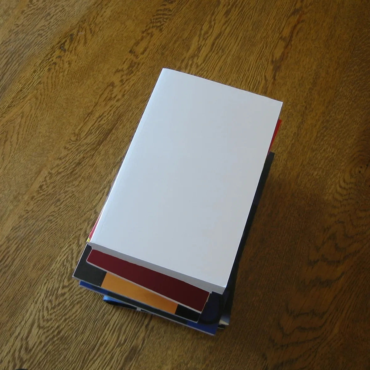 Stack of blank lotto entry coupons on a newsagent counter beside a printed odds table